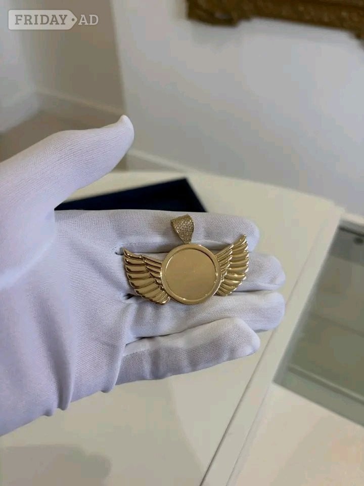 gold winged circle pendant