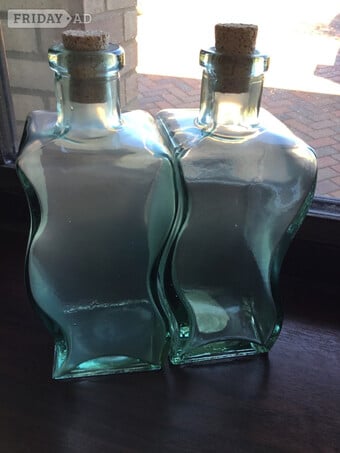 2 waved heavy glass bottles with cork stoppers