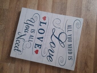 Wood framed 'love is all..' quote