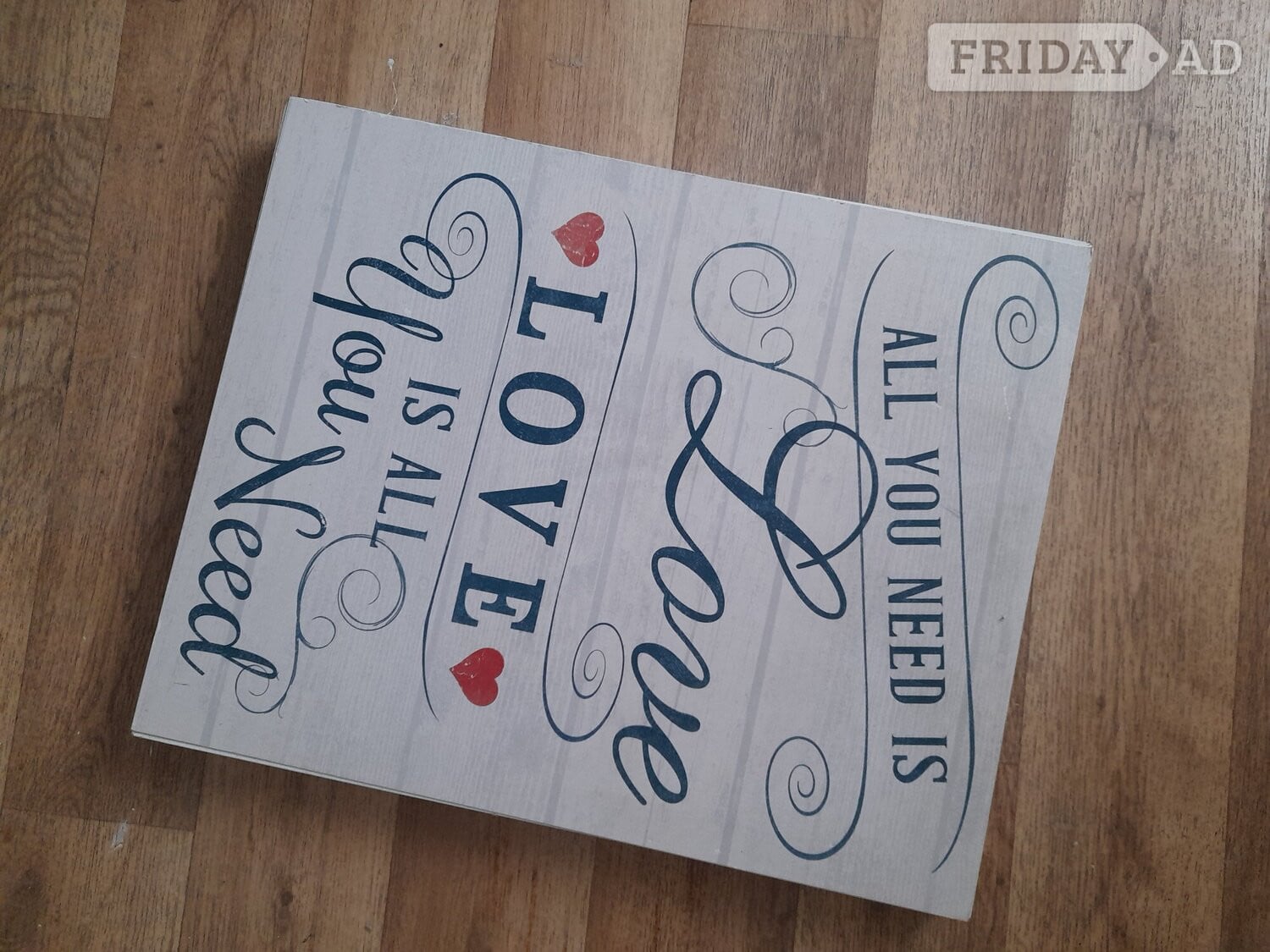 Wood framed 'love is all..' quote in Bristol