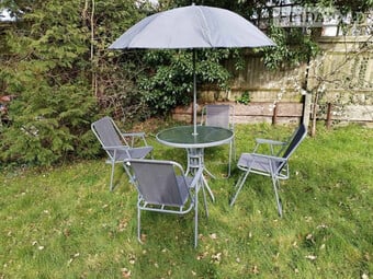 Round glass table, parasole and chairs, shows signs of rust but f