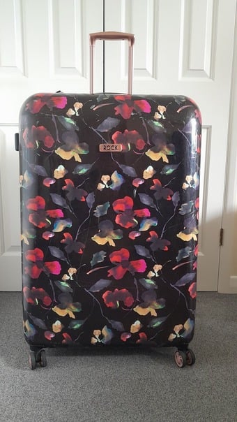 Rock, large, hard shell, four spinner wheeled  suitcase.