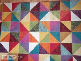 Large multi coloured triangle style floor rug