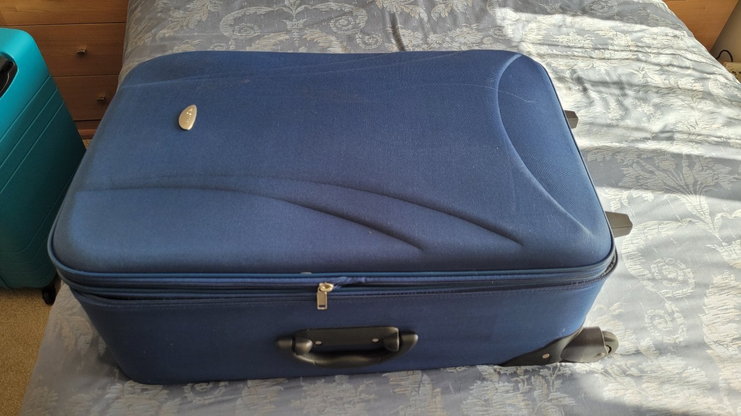 Large suitcase of brightly coloured leather offcuts