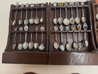 Commemorative Spoons from around the world mounted in racks