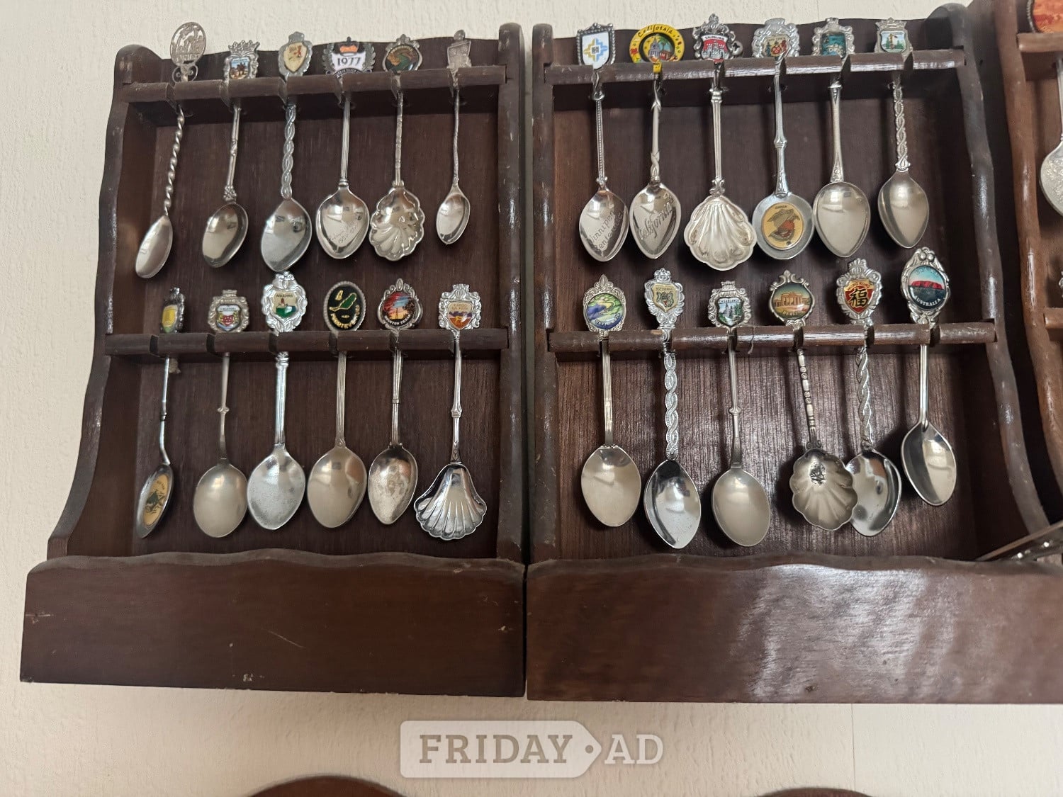 Commemorative Spoons from around the world mounted in racks in Worthing