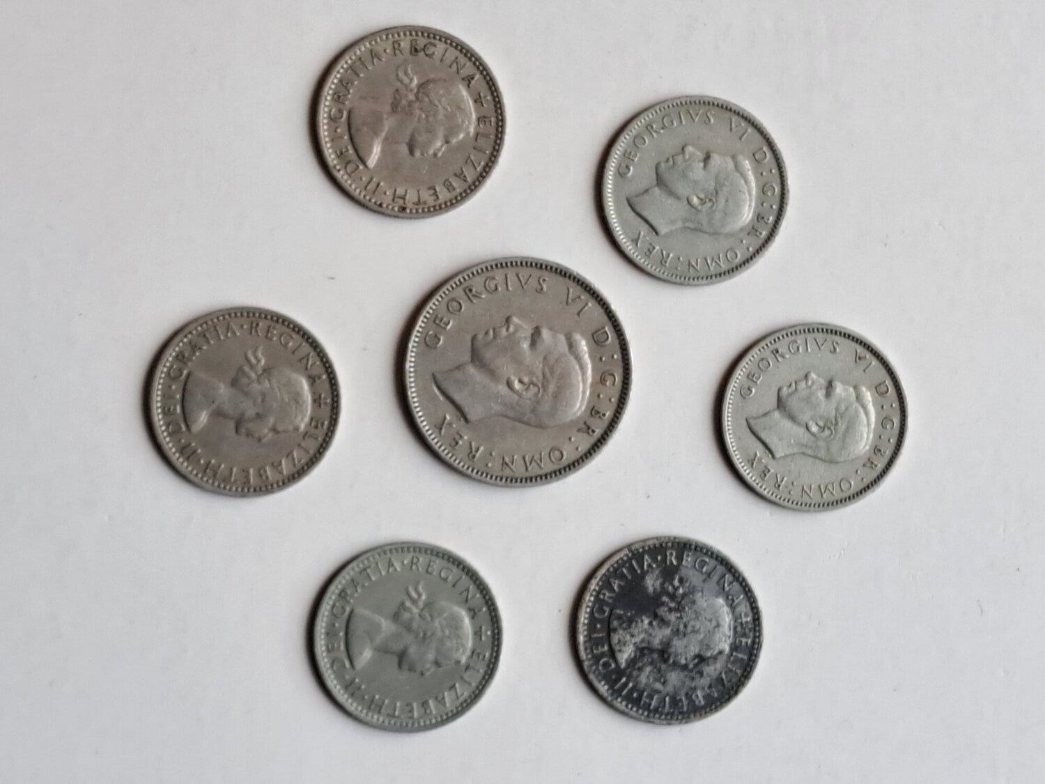 SMALL SILVER METAL COIN COLLECTION.  7 MIXED ENGLISH COINS.  USED