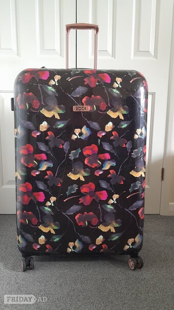 Rock, large, hard shell, four spinner wheeled  suitcase.