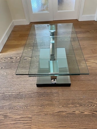 Swivel glass coffee table with 2 levels.