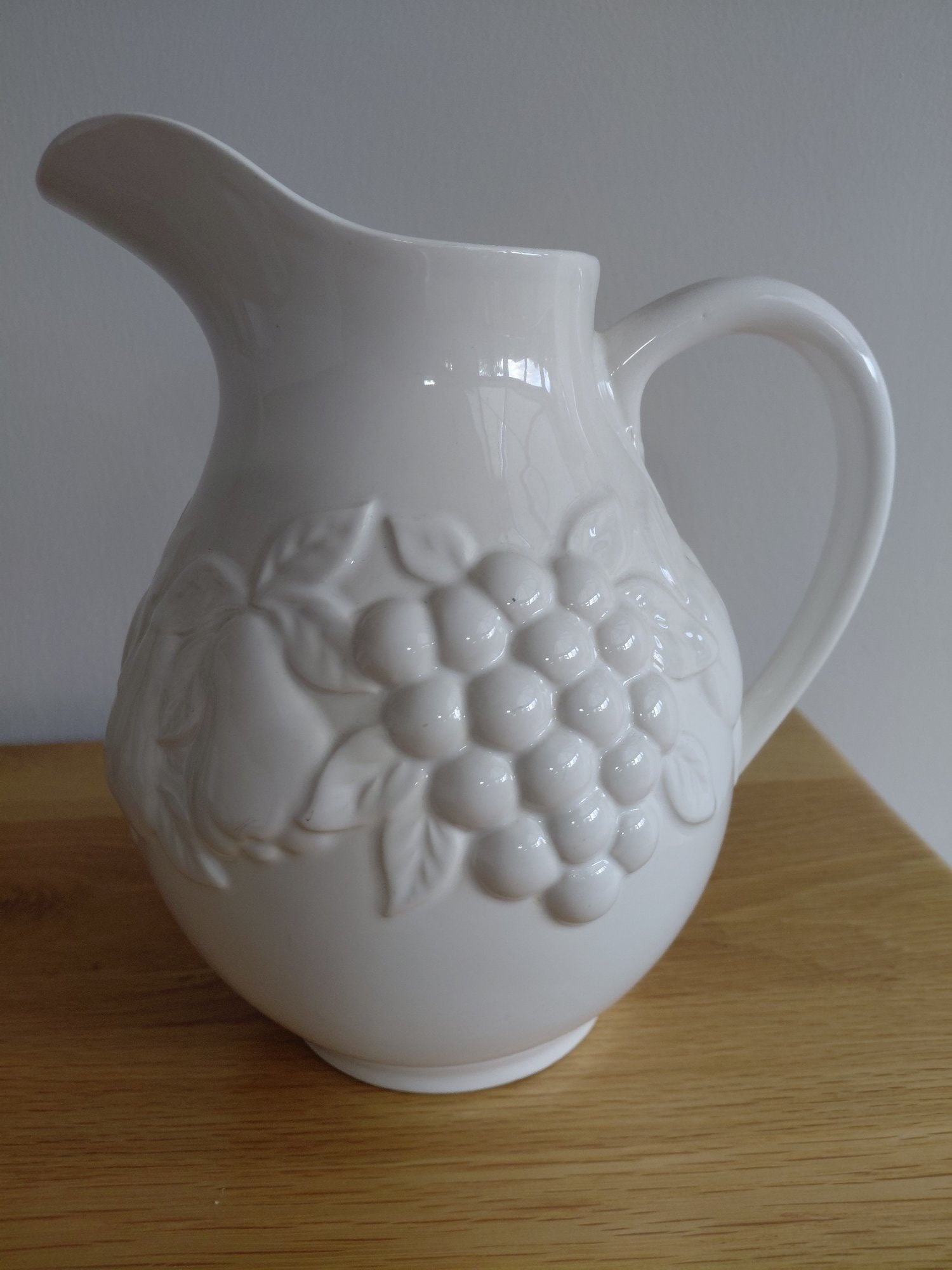 White Ceramic Jug with Fruit Embossing – Good Condition