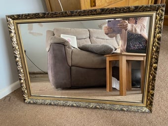 A large glass mirror your sitting room