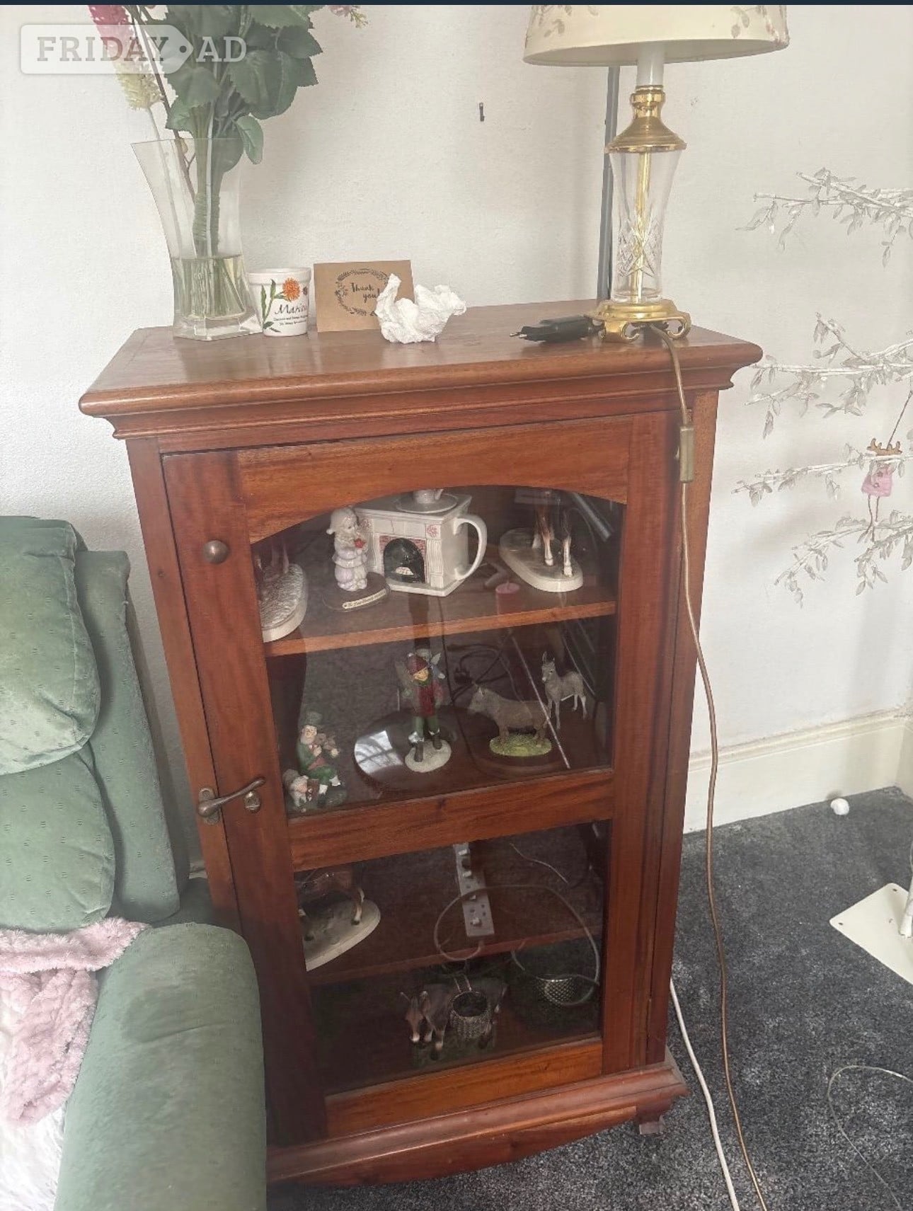 Gravesend Oak glass cabinet that has a brass handle.