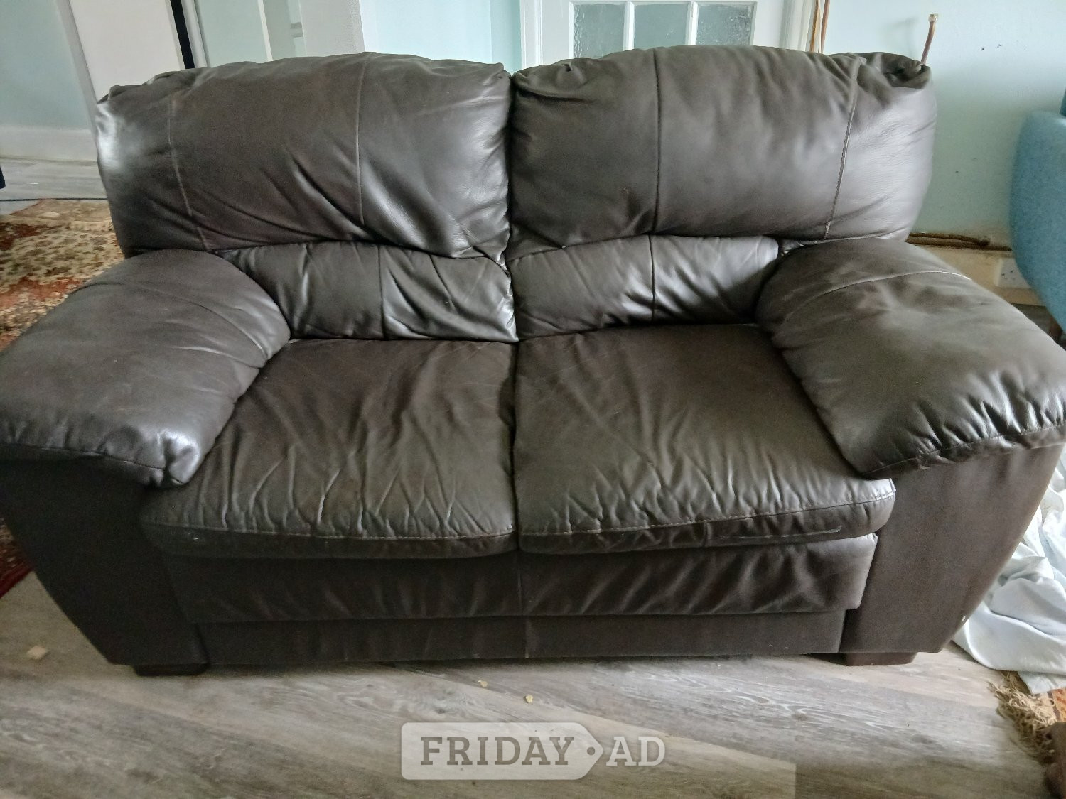 Brown leather two seater sofa in Lancing
