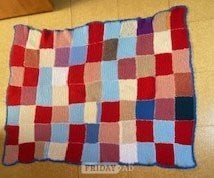 Hand-knitted multicolour patchwork blanket for children in Cardiff