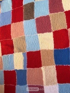Hand-knitted multicolour patchwork blanket for children