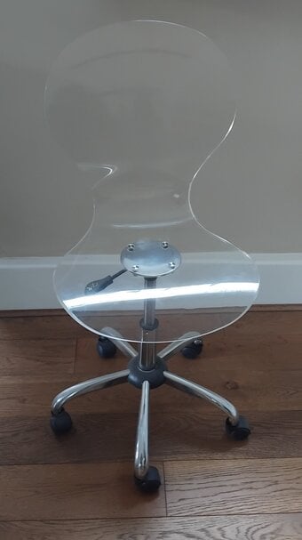 Clear acrylic chair on wheels