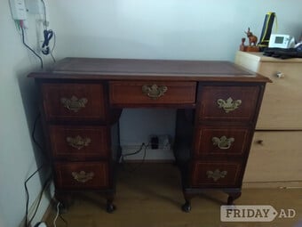 Antique table with a ladder on top, one is green and  one red