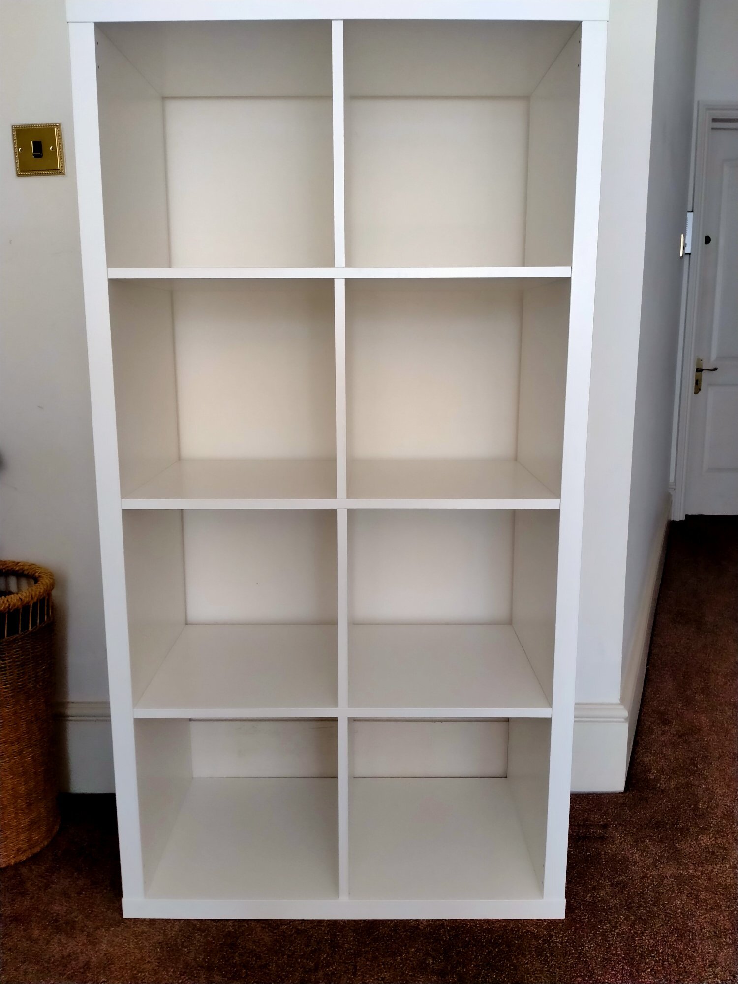 White cube storage unit with six assorted colourful storage boxes