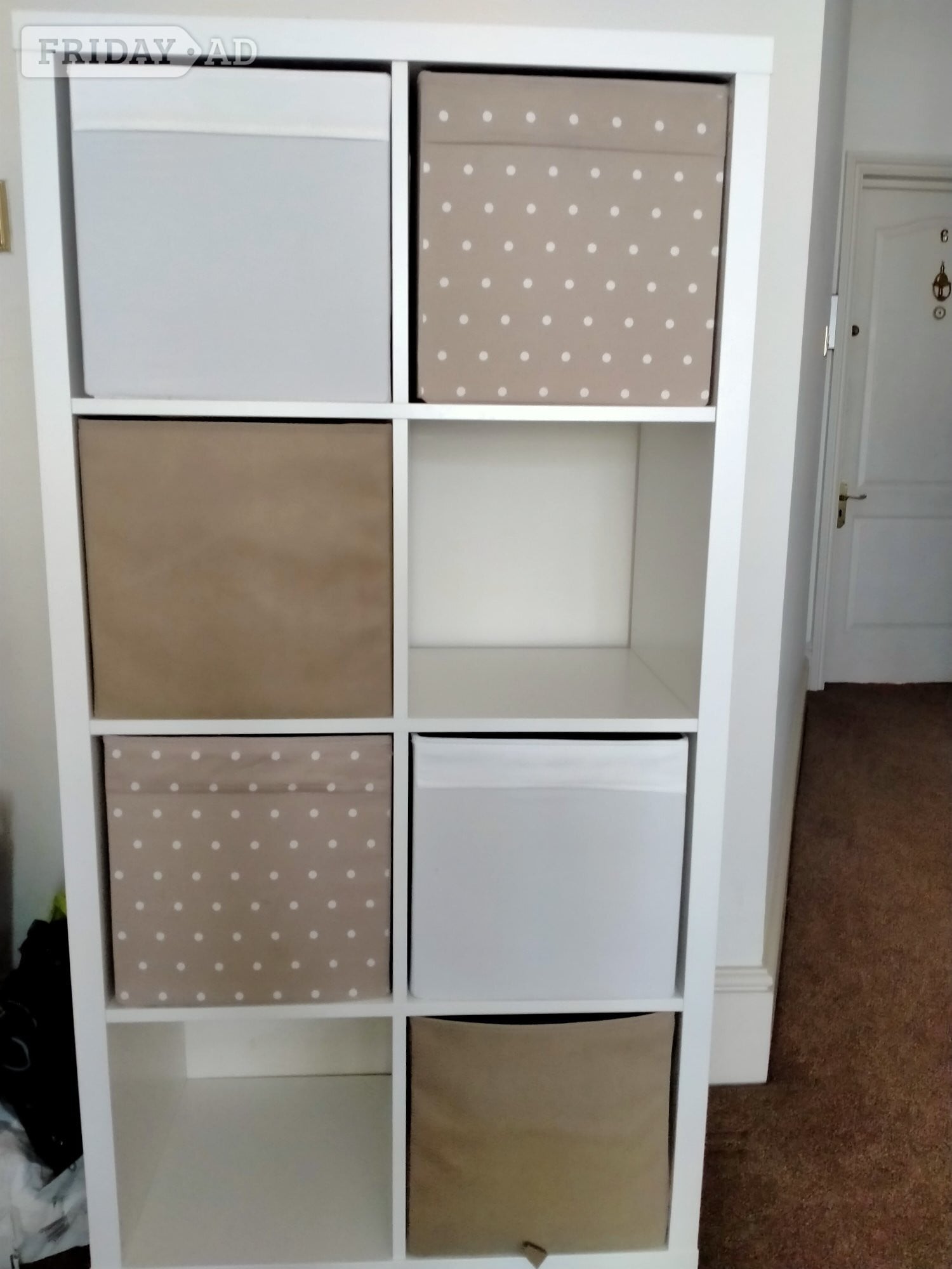 White cube storage unit with six assorted colourful storage boxes in Eastbourne