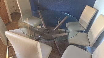 Round glass table with solid wood base and 6 chairs