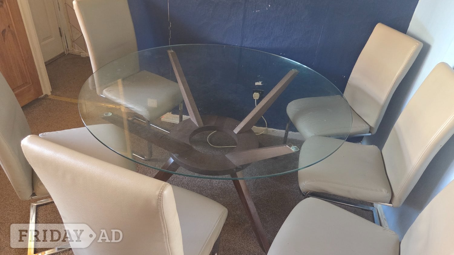 Round glass table with solid wood base and 6 chairs in Cardiff
