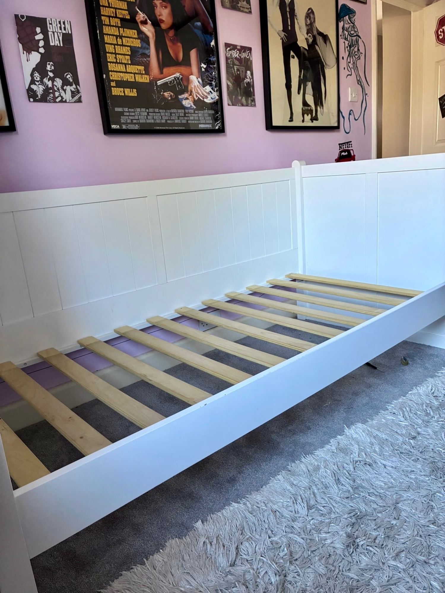 White daybed with mattress and pullout under bed. 