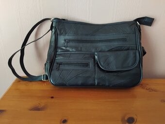 Brand new black leather handbag.