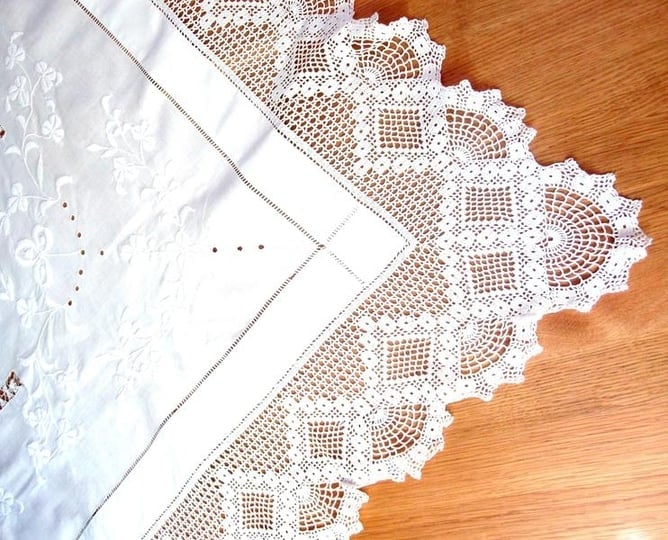 Tablecloth, white embroidered with lace surround.