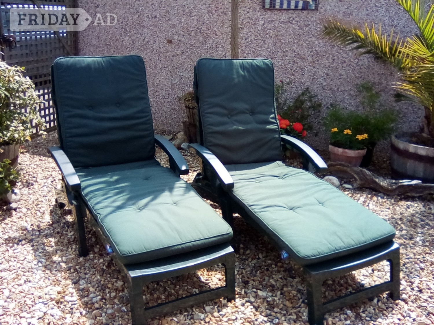 Two garden sunloungers with matching mattresses. 