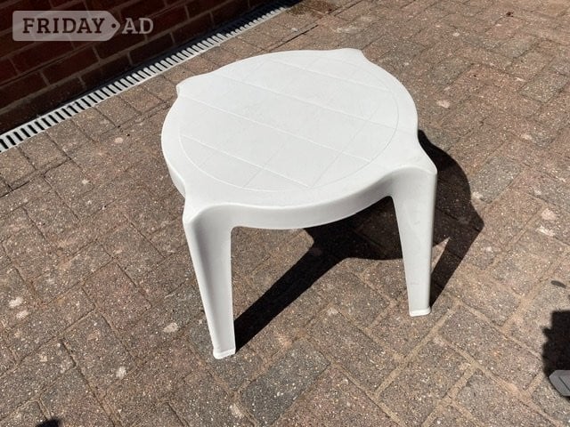 Three White PVC patio chairs, two with cushions plus table