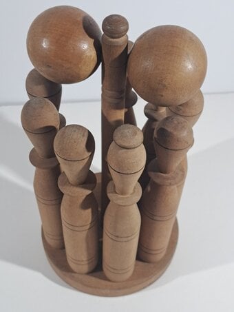 WOODEN SKITTLES AND BALLS ON STAND. ANTIQUE BOWLING GAME
