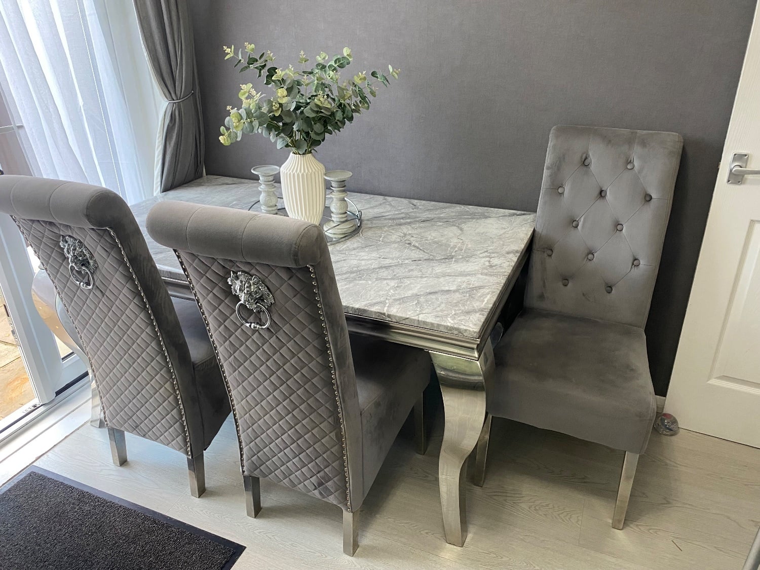 Grey and white marble dining table with 4 chairs and a bench