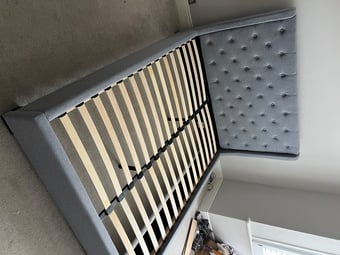 A lovely grey fabric king size bed frame.