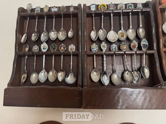 Commemorative Spoons from around the world mounted in racks