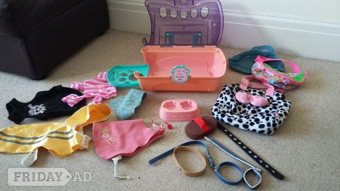 Shoreham-By-Sea Dolly pet carrier with various clothes / coats, collars, brush, pet bags and feeding plate.