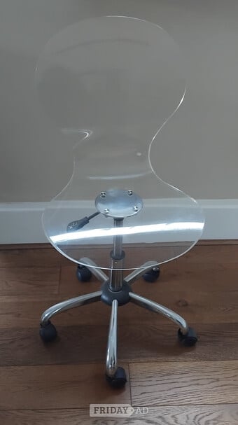 Clear acrylic chair on wheels