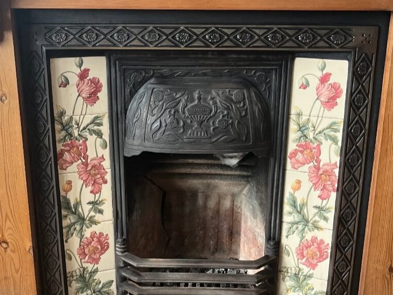 CAST IRON FIRE PLACE WITH PINE SURROUND
