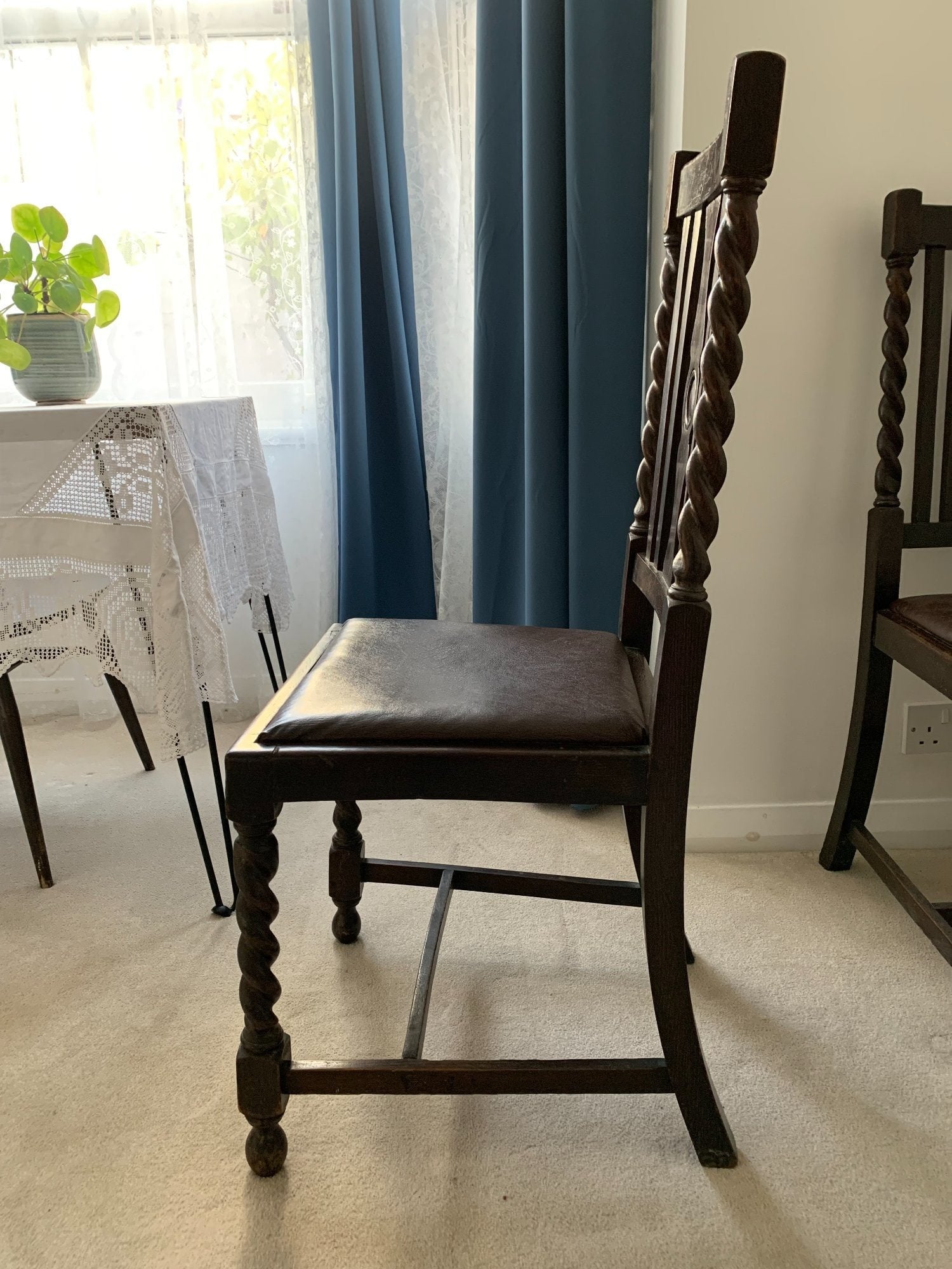 Two dark wood vintage chairs with barley twist legs and leather seats
