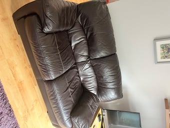 Two, two seater leather sofas plus storage footstall