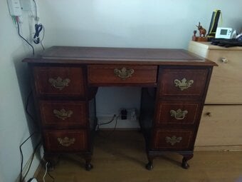 Antique table with a ladder on top, one is green and  one red